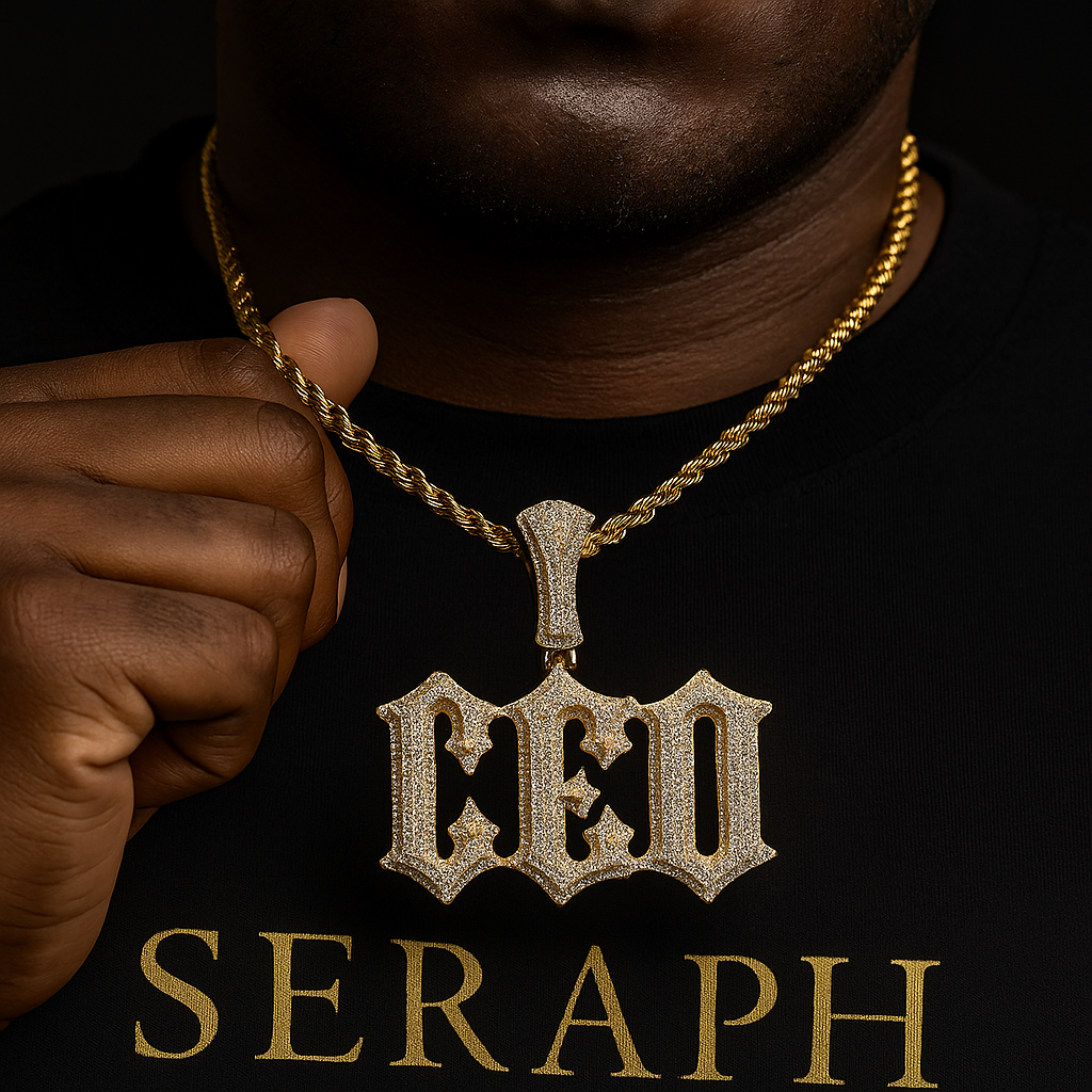 Gothic‑style pendant spelling a custom name, embellished with stones and gold plating.