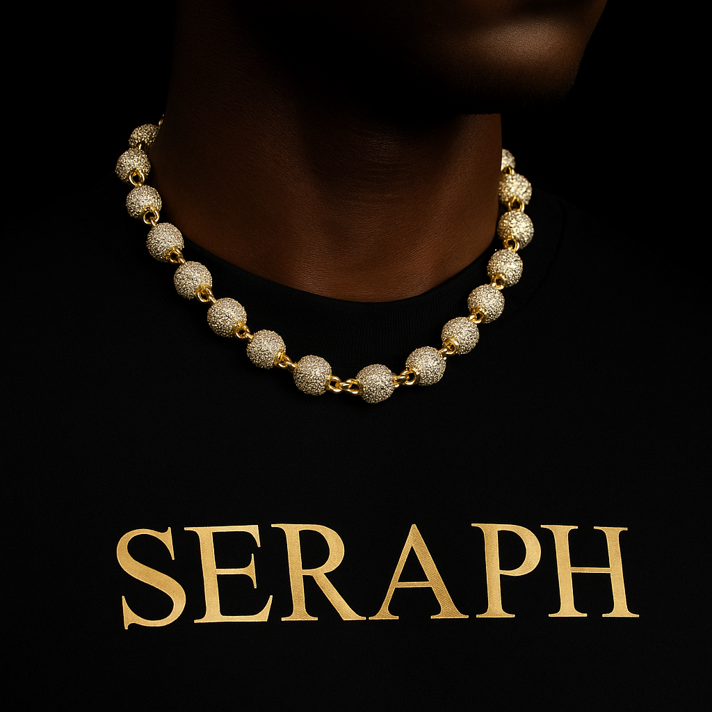 Necklace with small gold‑tone spheres distributed along the chain.