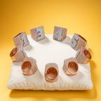 Group of rings with customized letters encrusted in baguette moissanite diamonds and gold plated.